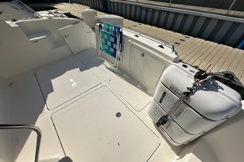 Slide: The Image of 2007 Meridian 411 Sedan boat deck with storage compartments and safety equipment. - 64