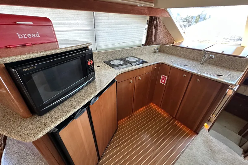 Slide: The Image of Luxurious 2007 Meridian 411 Sedan yacht kitchen with microwave, stove, and sink. - 50