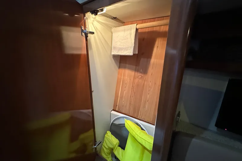 Slide: The Image of Interior of 2007 Meridian 411 Sedan closet with wooden paneling and hanging towel. - 76