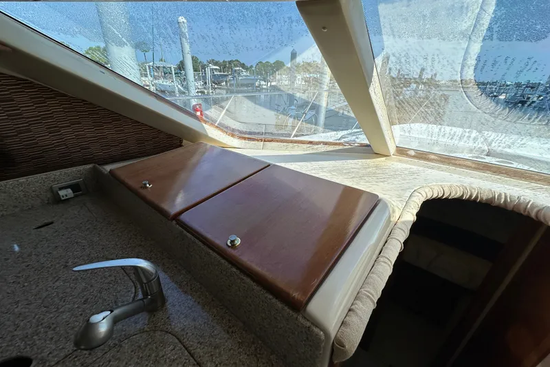 Slide: The Image of Interior view of 2007 Meridian 411 Sedan yacht with wooden countertop and faucet. - 90