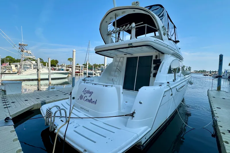 Slide: The Image of 2007 Meridian 411 Sedan yacht docked at marina under clear blue sky. - 17