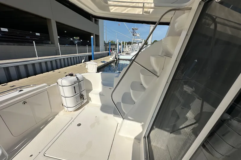 Slide: The Image of 2007 Meridian 411 Sedan yacht docked, featuring sleek white design and outdoor staircase. - 63