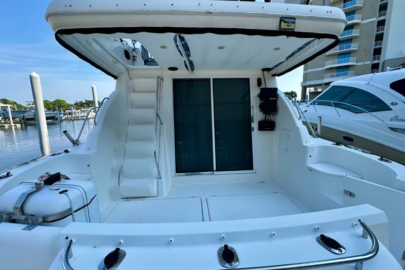 Slide: The Image of 2007 Meridian 411 Sedan yacht stern view with stairs and marina backdrop. - 28