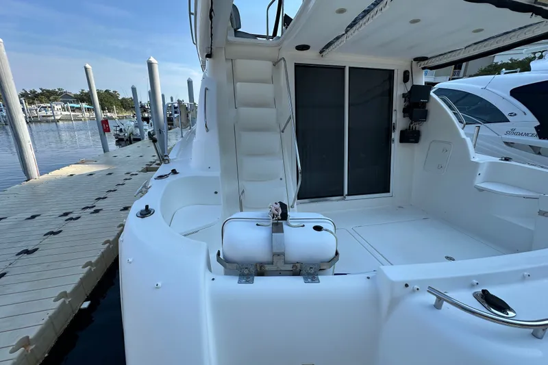 Slide: The Image of 2007 Meridian 411 Sedan yacht docked, showcasing spacious deck and sleek design. - 30