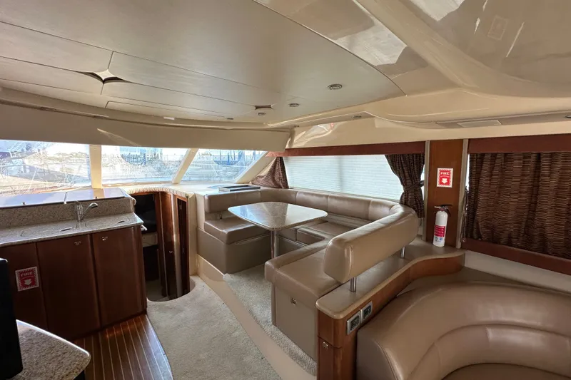 Slide: The Image of Luxurious interior of a 2007 Meridian 411 Sedan yacht with plush seating and kitchenette. - 57