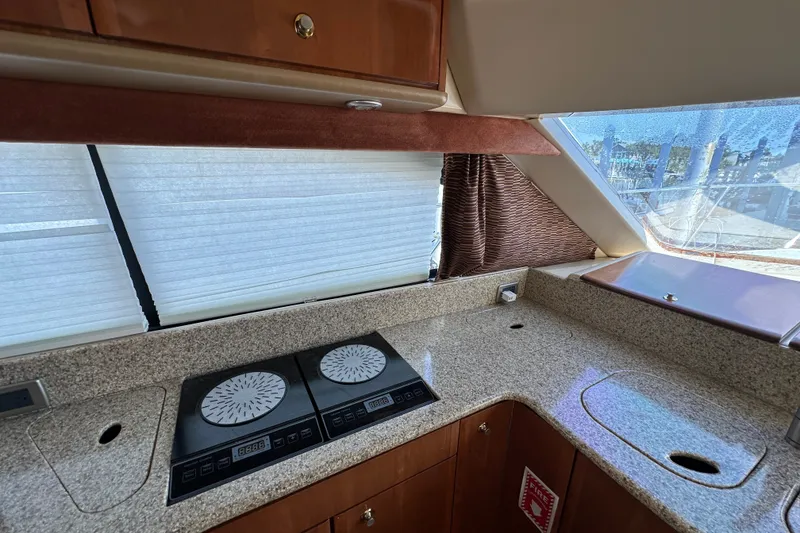 Slide: The Image of 2007 Meridian 411 Sedan yacht kitchen with granite countertops and induction cooktop. - 116
