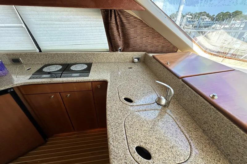 Slide: The Image of Luxurious 2007 Meridian 411 Sedan yacht kitchen with granite countertops and modern appliances. - 91