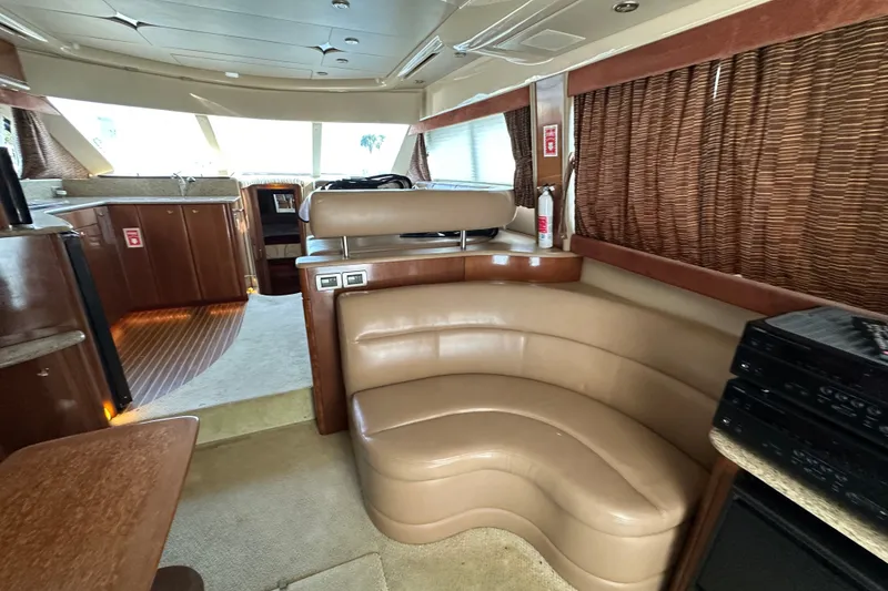 Slide: The Image of Luxurious interior of a 2007 Meridian 411 Sedan yacht with leather seating and wood accents. - 44