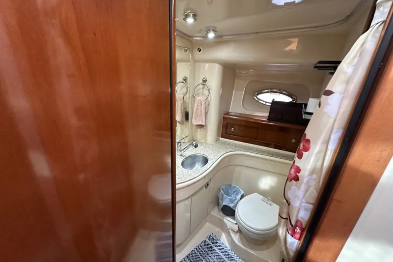 Slide: The Image of Bathroom interior of 2007 Meridian 411 Sedan yacht with sink, toilet, and floral shower curtain. - 85