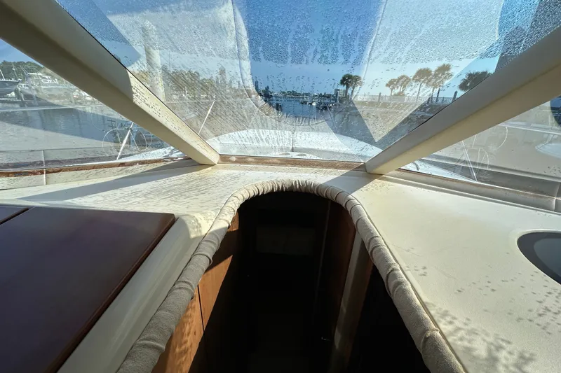 Slide: The Image of Interior view of 2007 Meridian 411 Sedan yacht with sunlit cabin and marina backdrop. - 87