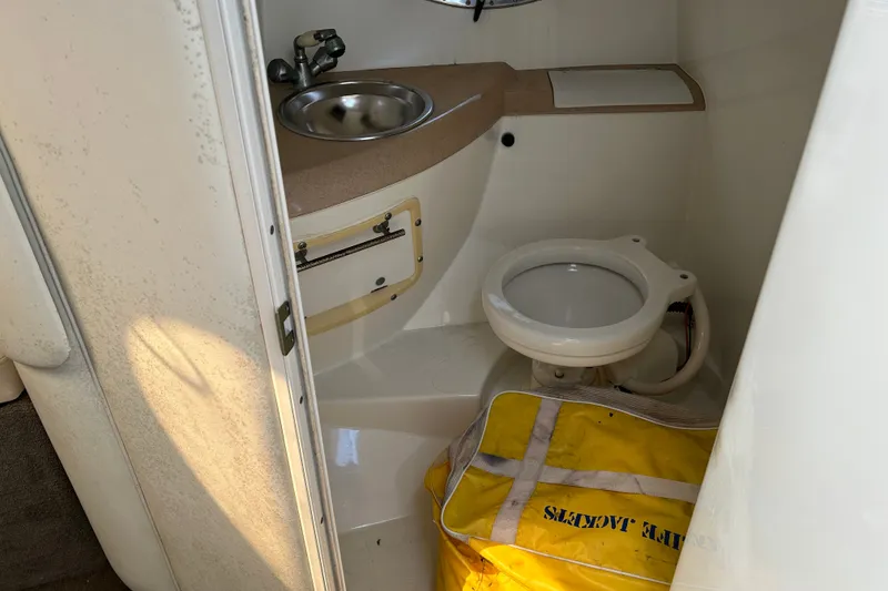 Slide: The Image of Compact bathroom in a 1998 Cobalt 293 boat with sink and toilet. - 14