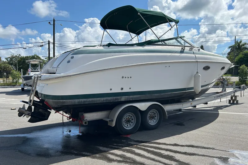 Slide: The Image of 1998 Cobalt 293 boat on trailer under blue sky with clouds. - 1