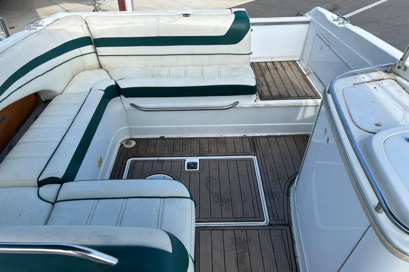 Slide: The Image of Interior of a 1998 Cobalt 293 boat with white and green seating. - 11