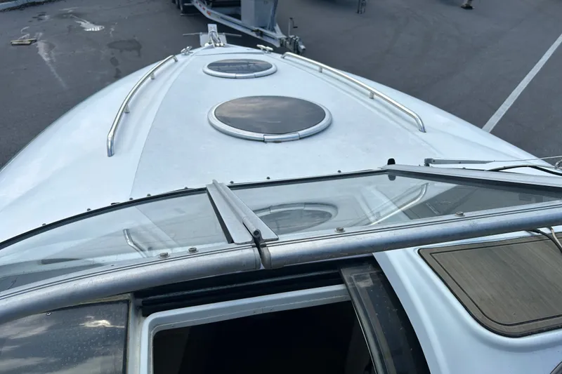 Slide: The Image of 1998 Cobalt 293 boat deck with circular hatches and metal railings. - 7