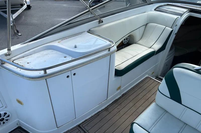 Slide: The Image of Interior of a 1998 Cobalt 293 boat with white seating and wooden flooring. - 9