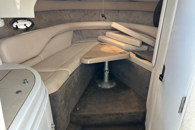 Slide: The Image of Interior cabin of a 1998 Cobalt 293 boat with beige seating and table. - 12