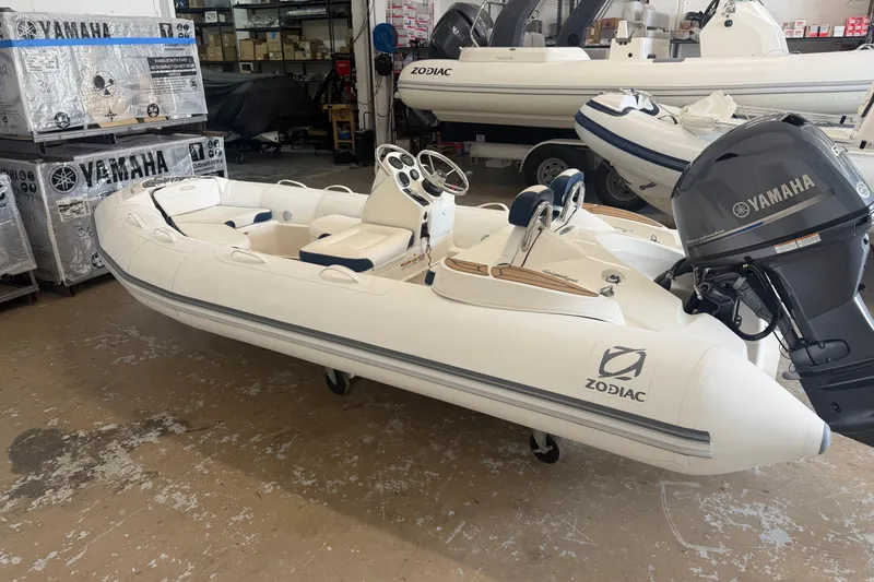 Slide: The Image of 2020 Zodiac Yachtline 440 inflatable boat with Yamaha outboard motor in a showroom. - 1