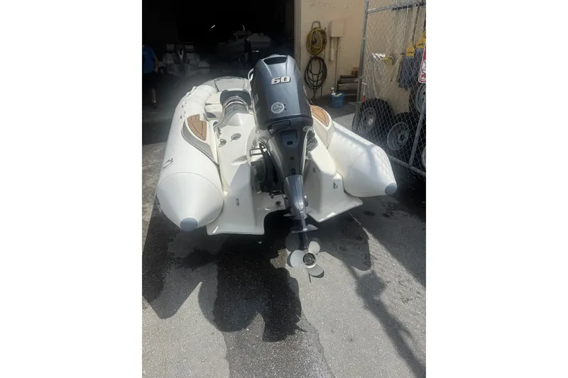 Slide: The Image of 2020 Zodiac Yachtline 440 inflatable boat with outboard motor in a storage area. - 12