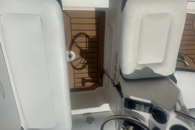 Slide: The Image of Interior of a 2020 Zodiac Yachtline 440, featuring white seating and wooden flooring. - 10