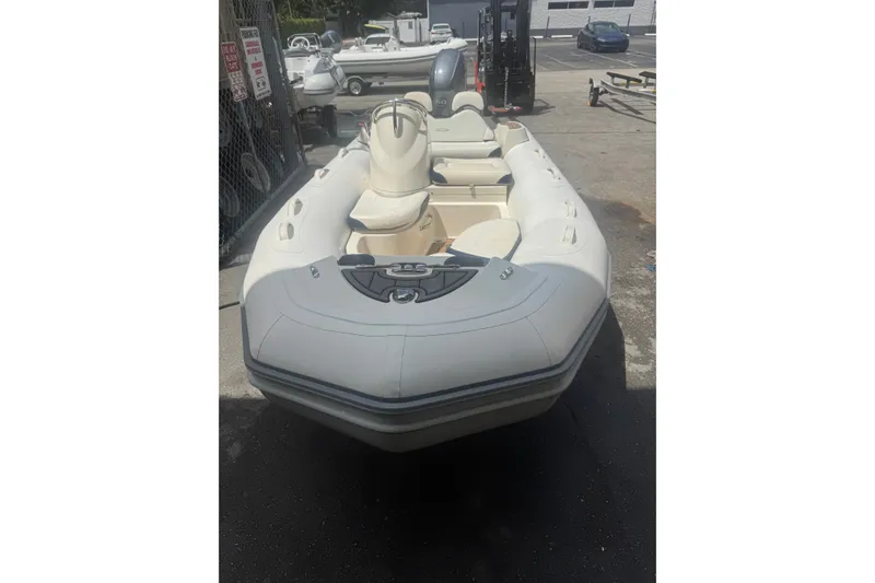 Slide: The Image of 2020 Zodiac Yachtline 440 inflatable boat in a parking area. - 2