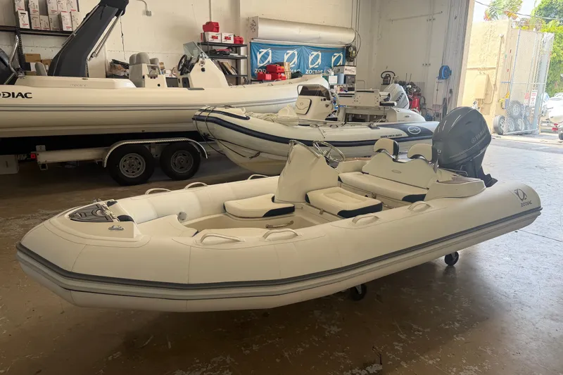 Slide: The Image of 2020 Zodiac Yachtline 440 inflatable boat in showroom, featuring sleek design and Yamaha outboard motor. - 4