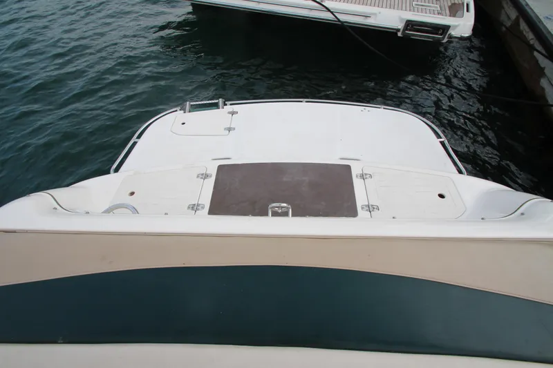 Slide: The Image of 1999 Bryant 182 boat stern view at dock, featuring swim platform. - 20
