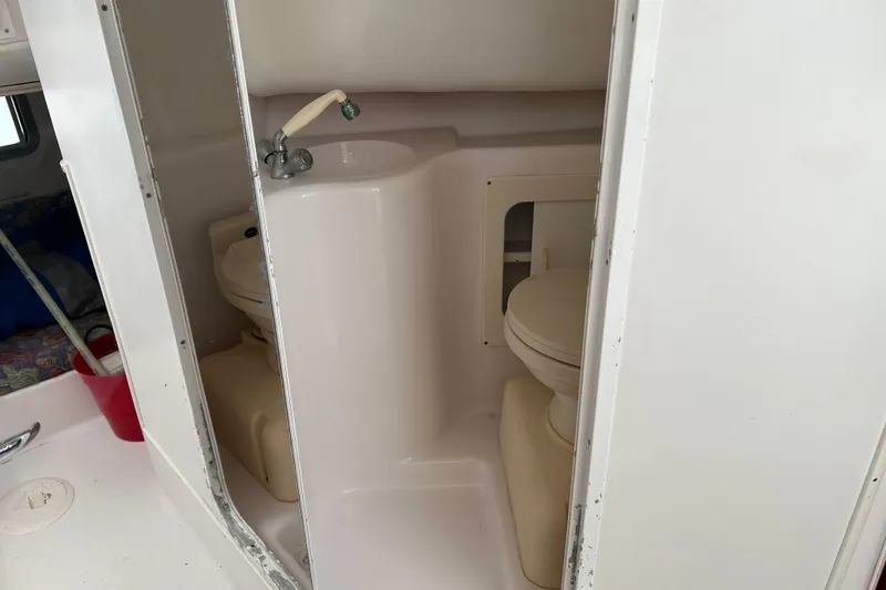 Slide: The Image of 2000 Pro-Line 30 Walkaround boat bathroom with sink and toilet. - 16