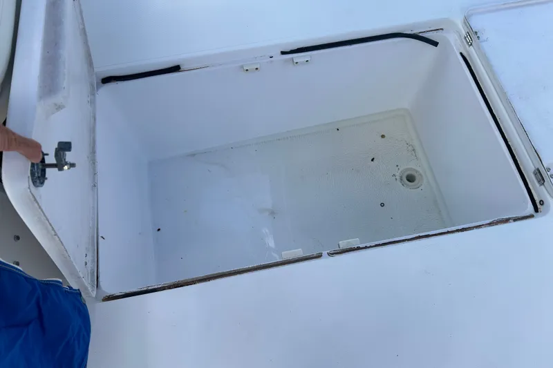 Slide: The Image of Open storage compartment on a 2000 Pro-Line 30 Walkaround boat. - 17