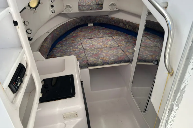 Slide: The Image of Interior cabin of a 2000 Pro-Line 30 Walkaround boat with patterned cushions. - 14