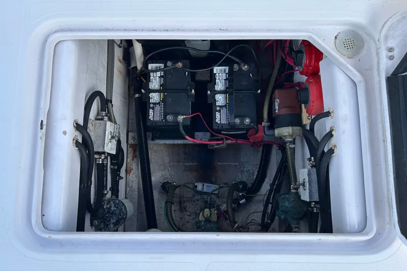 Slide: The Image of Battery compartment of a 2000 Pro-Line 30 Walkaround boat, showing wiring and components. - 18