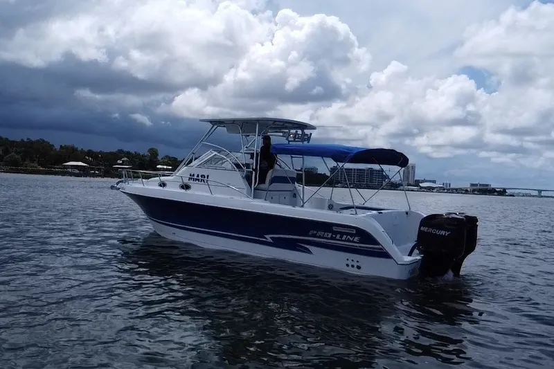 Slide: The Image of 2000 Pro-Line 30 Walkaround boat on water under cloudy sky. - 21
