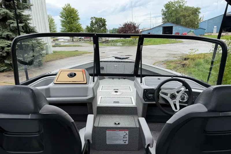 Slide: The Image of Interior view of 2027 Starcraft Fishmaster 196 boat cockpit with steering wheel. - 25