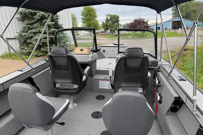 Slide: The Image of Interior of a 2027 Starcraft Fishmaster 196 boat with seating and steering console. - 5