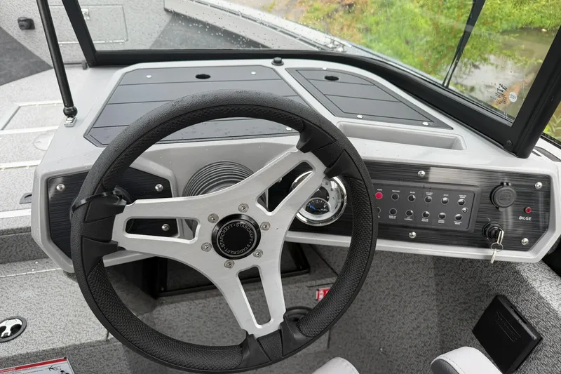 Slide: The Image of Steering console of 2027 Starcraft Fishmaster 196 boat with control panel and gauges. - 6