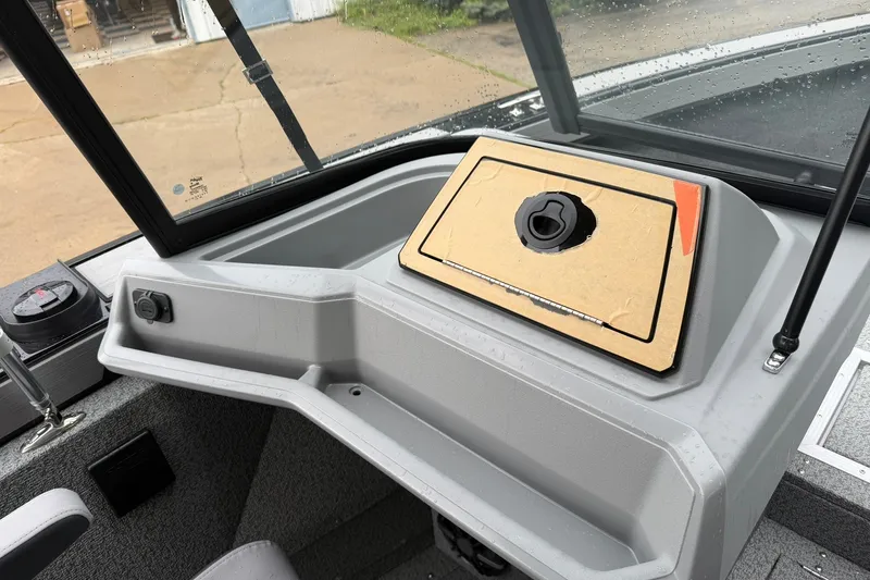 Slide: The Image of 2027 Starcraft Fishmaster 196 boat dashboard with compass and storage compartment. - 10