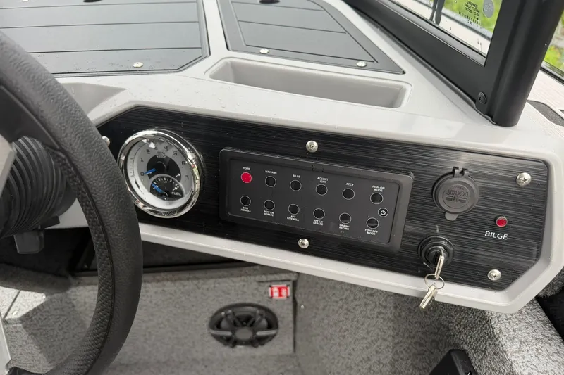 Slide: The Image of Dashboard of 2027 Starcraft Fishmaster 196 boat with controls and gauges. - 7