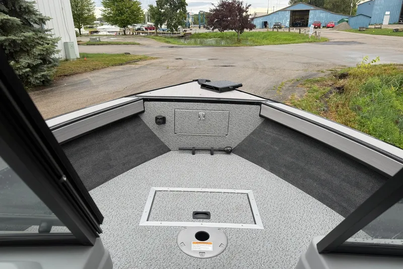 Slide: The Image of 2027 Starcraft Fishmaster 196 boat interior, featuring spacious deck and storage compartments. - 9