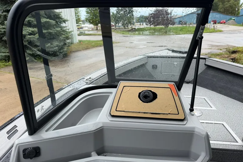 Slide: The Image of 2027 Starcraft Fishmaster 196 boat interior with windshield and storage compartment. - 24
