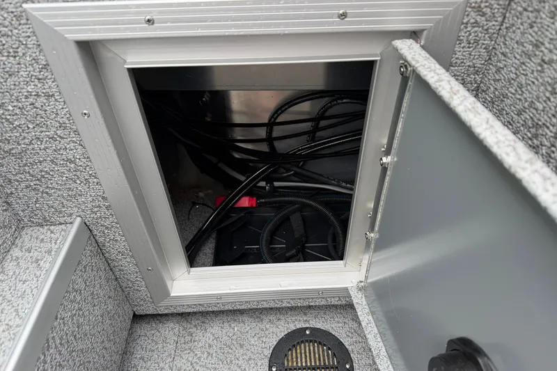 Slide: The Image of Open compartment in 2027 Starcraft Fishmaster 196 boat showing wiring and components. - 21