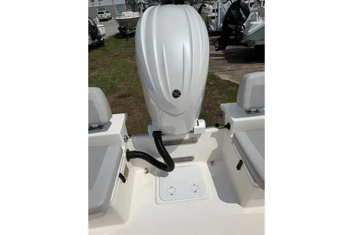 Slide: The Image of 2024 KenCraft 2460 Bayrider boat engine and seating area, outdoor display. - 20