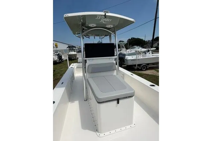 Slide: The Image of 2024 KenCraft 2460 Bayrider boat with center console and seating, displayed outdoors. - 14