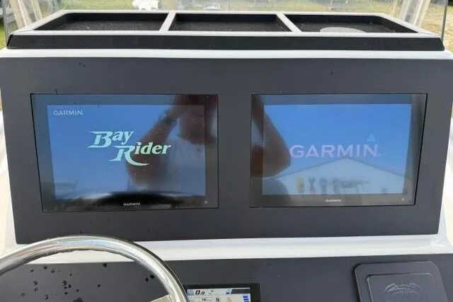 Slide: The Image of 2024 KenCraft 2460 Bayrider dashboard with dual Garmin displays. - 29