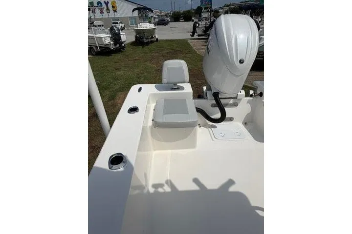 Slide: The Image of 2024 KenCraft 2460 Bayrider boat with outboard motor and seating, displayed outdoors. - 19