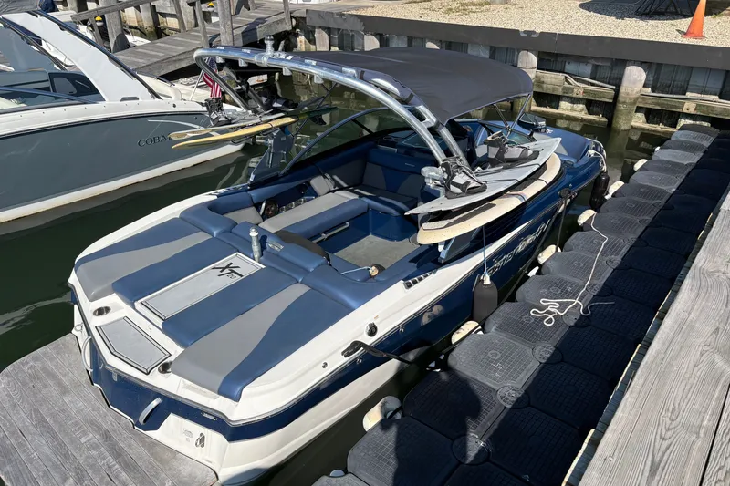 The Image of 2019 MasterCraft X20 boat docked, featuring sleek design and wakeboard equipment. - 1