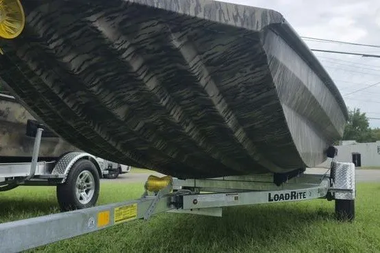 Slide: The Image of 2027 Havoc 1656 MRST MACH 1 boat on Load Rite trailer, grass background. - 12