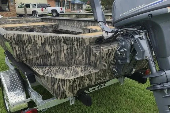 Slide: The Image of 2027 Havoc 1656 MRST MACH 1 boat on trailer with camouflage design and motor. - 15