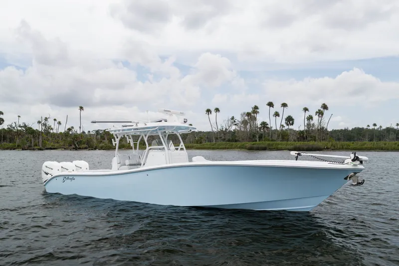 Slide: The Image of 2019 Yellowfin 36 Offshore boat on water with palm trees in background. - 3