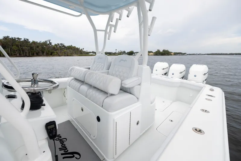 Slide: The Image of 2019 Yellowfin 36 Offshore boat interior with seating and multiple outboard engines. - 35