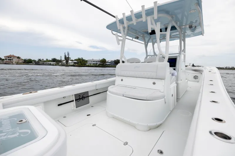 Slide: The Image of 2019 Yellowfin 36 Offshore boat on water, showcasing spacious deck and seating. - 38