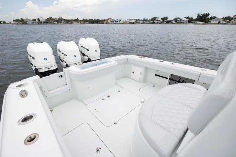 Slide: The Image of 2019 Yellowfin 36 Offshore boat with triple outboard engines on calm water. - 43